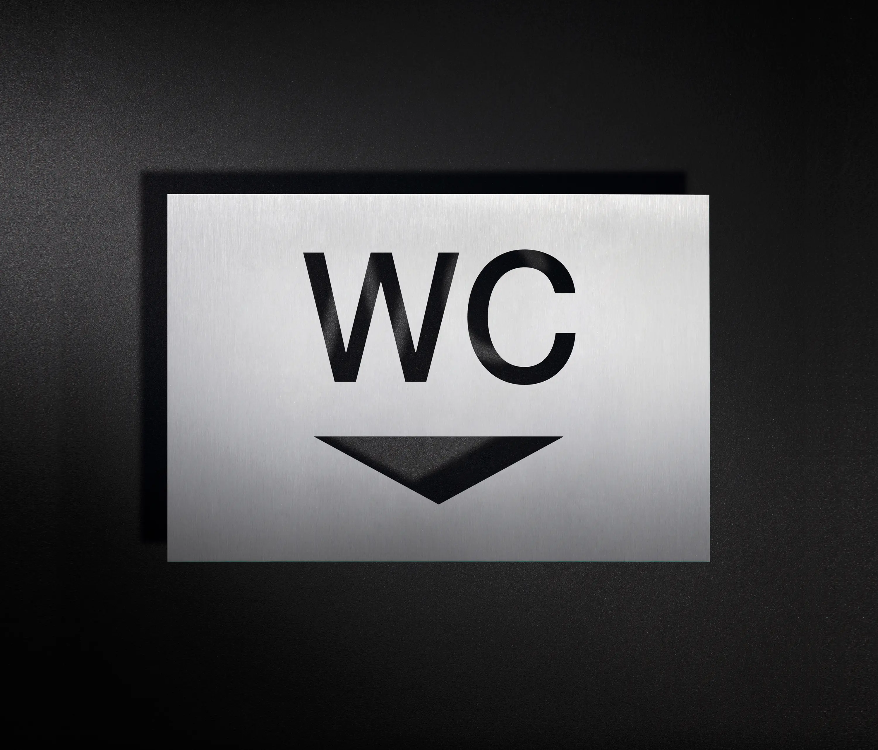 PHOS Design - WC sign combination with directional arrow pointing downwards