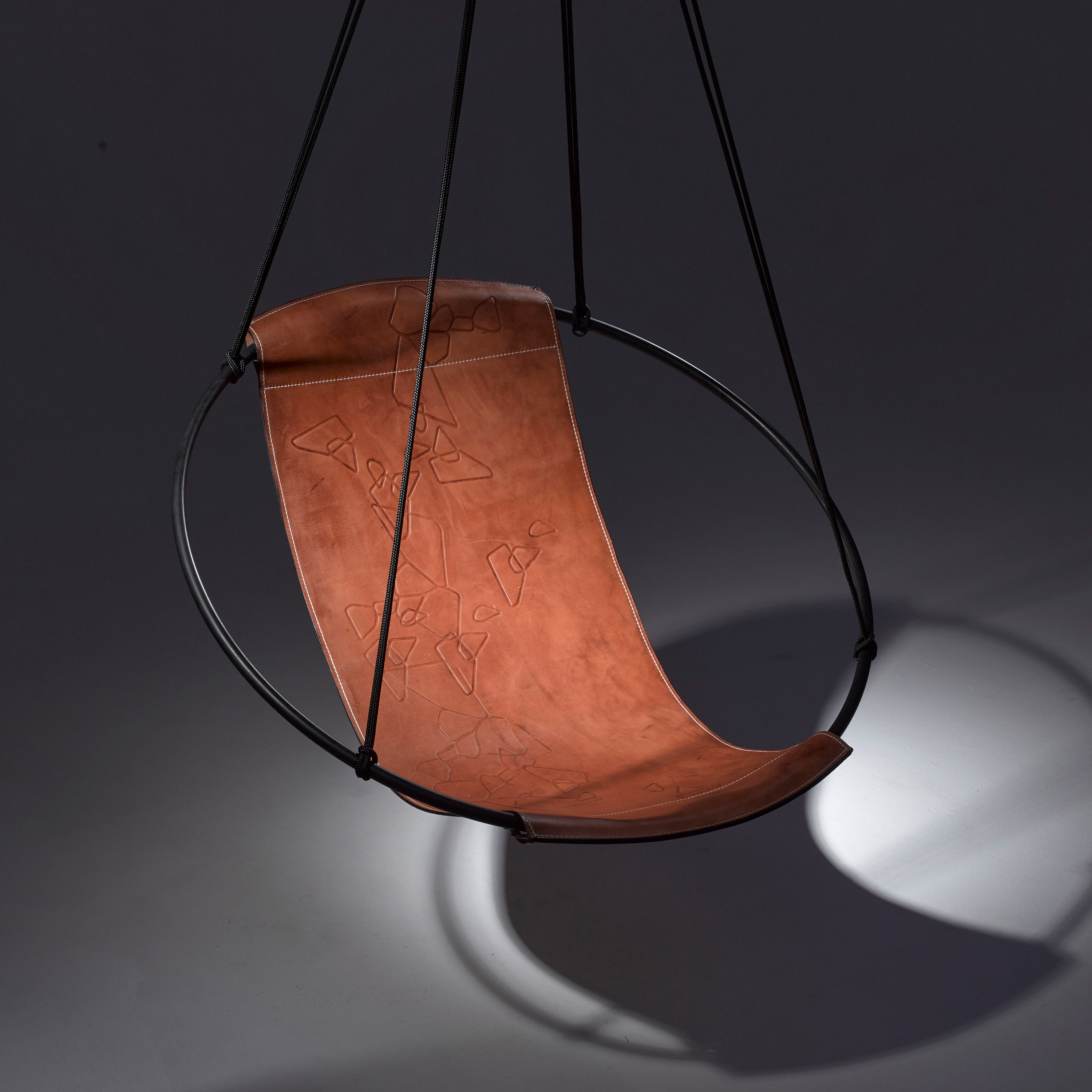 Display product Sling Hanging Chair - Debossed Leather Geometrics from manufacturer Studio Stirling