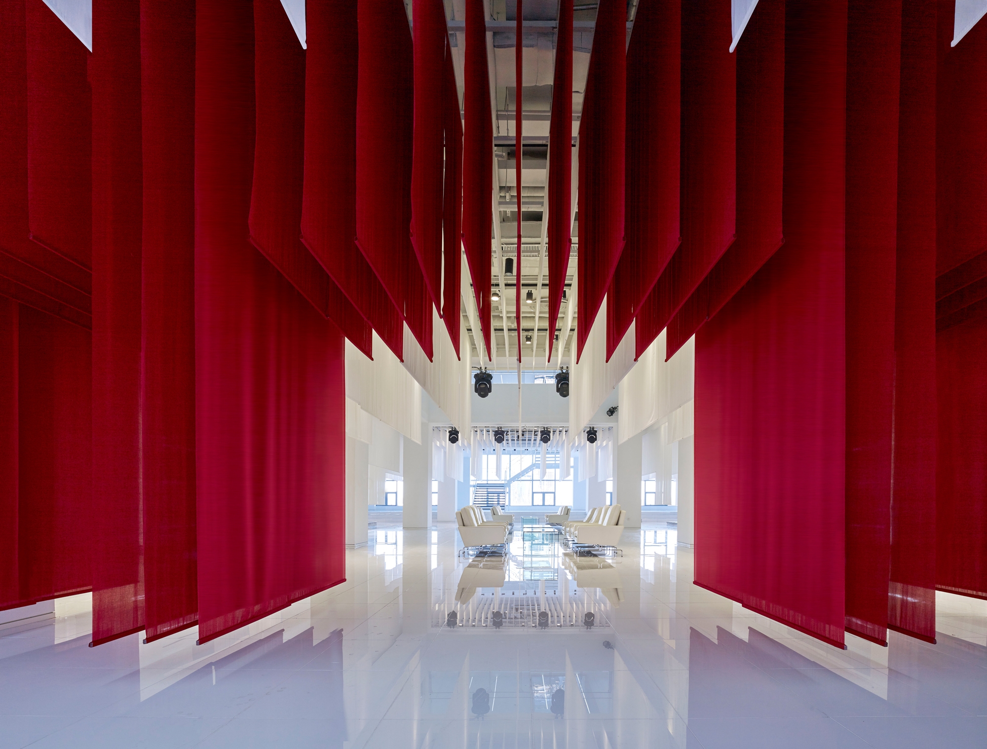 Beijing’s Zhengtong BMW Museum, designed by Crossboundaries, sees suspended textile planes create architectural volume via a compelling layering.  Photos: YANG Chao Ying