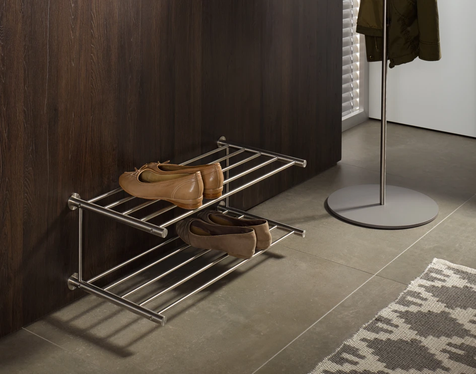 Make a good first impression: freestanding and wall-mounted shoe shelves and round stainless steel wardrobe for the corridor