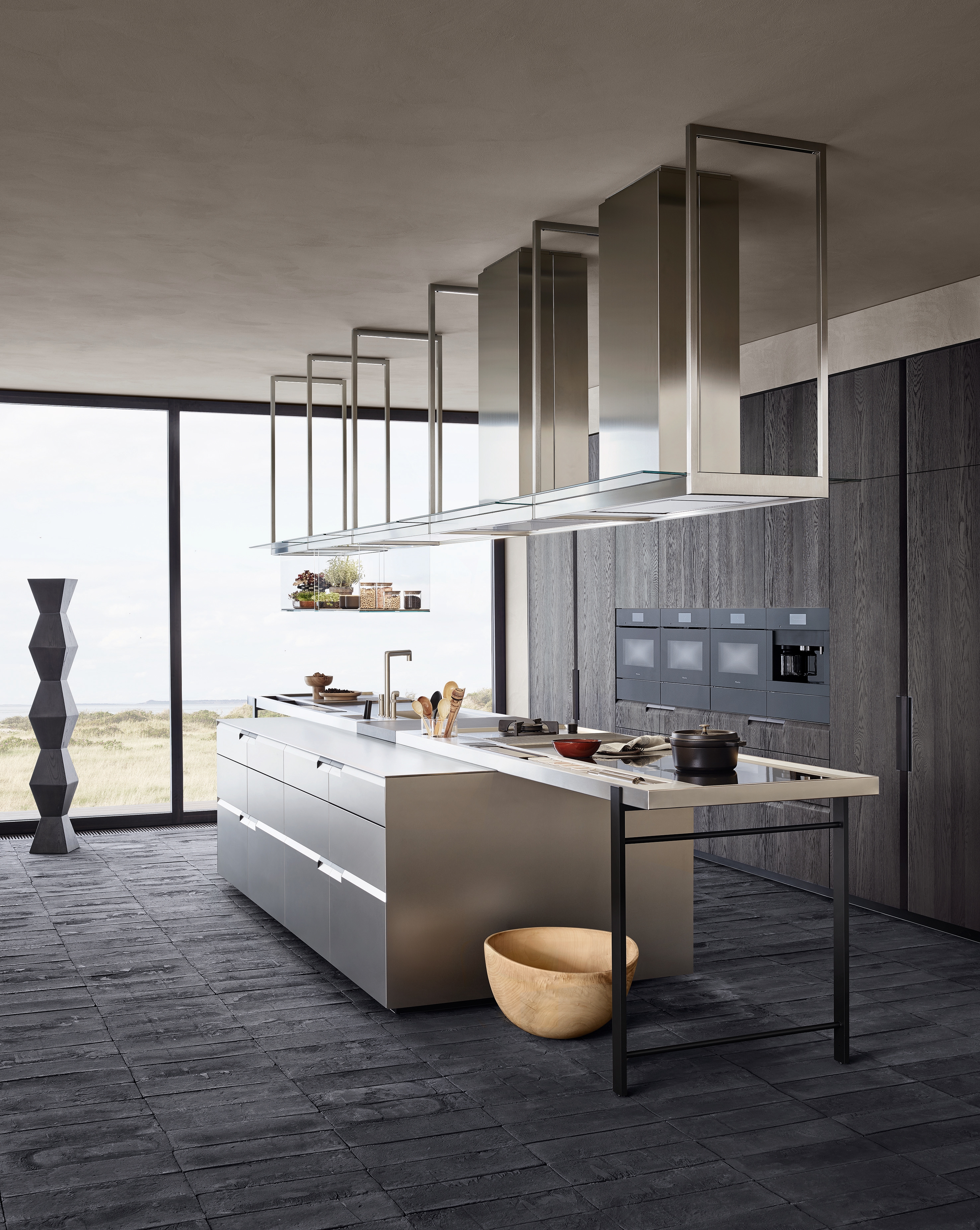 The Shape kitchen created by R&D Poliform exudes clean-lined Nordic style: sleek base units are paired with a steel-topped peninsula