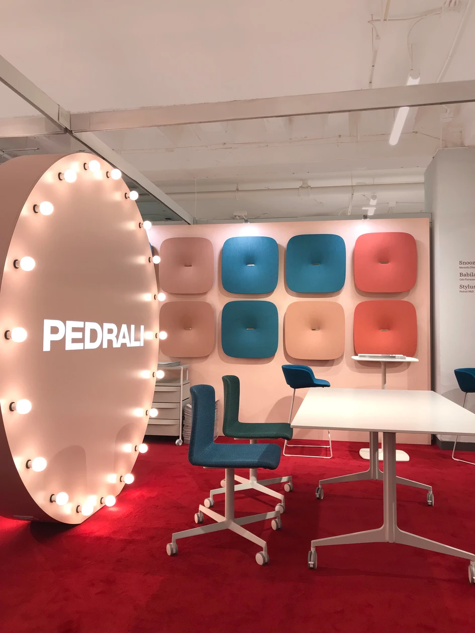 The display at NeoCon featured circular walls fitted with lightbulbs that highlighted and illuminated Pedrali’s latest collections