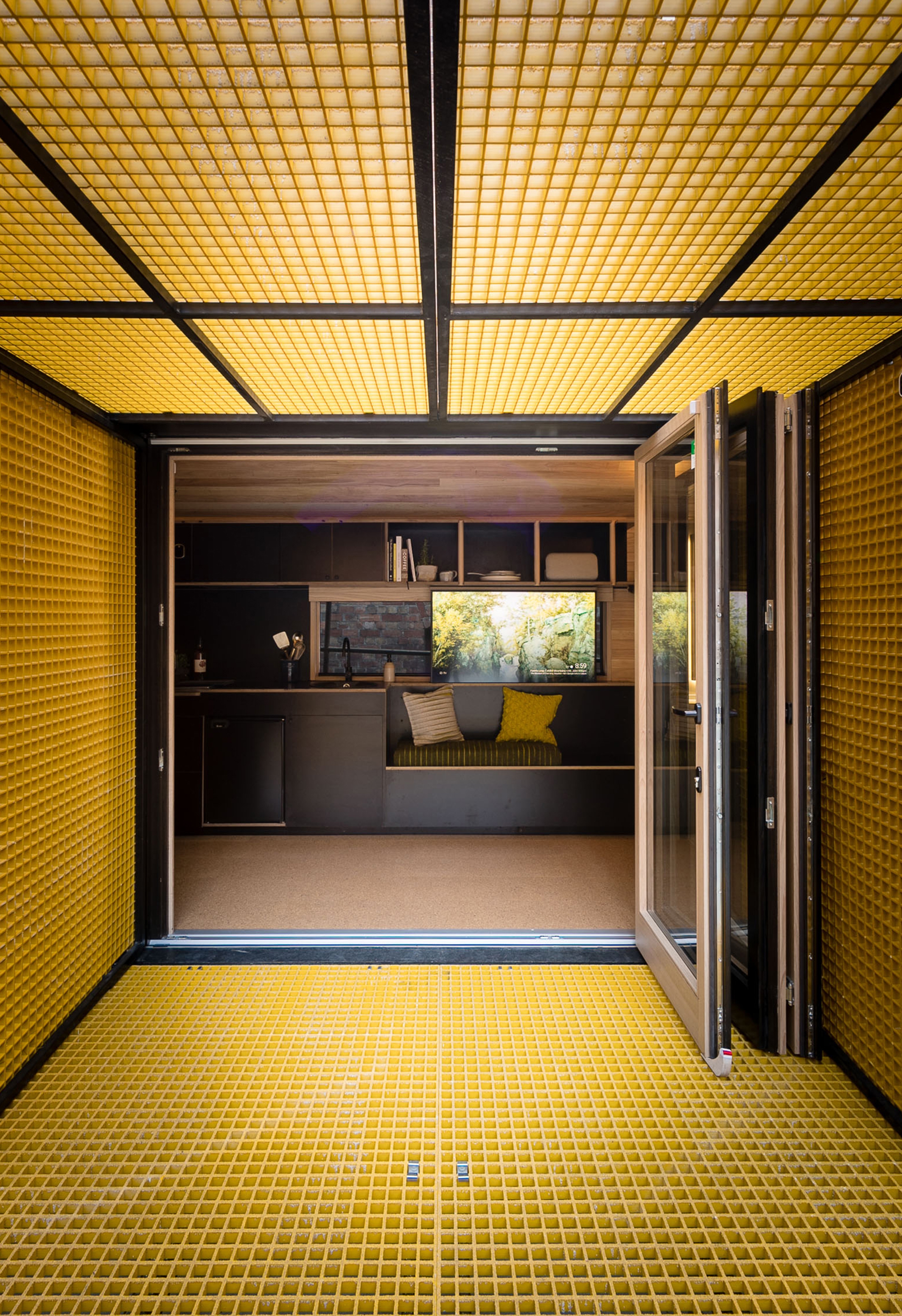 Like many rural micro houses, Tiny Home by Maddison Architects incorporates photovoltaic panels, highly insulated outer walls, and is designed to be able to be transported by a lorry and function off-grid.  Photographer: Beechworth Photographers