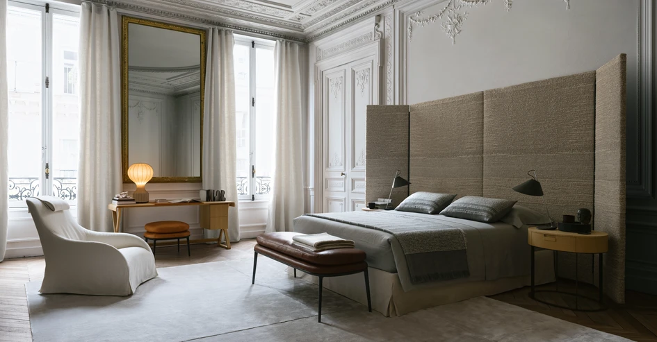 The Dike bed features a large headboard that also functions as an architectural screen, defining space and introducing a theatrical element to the bedroom