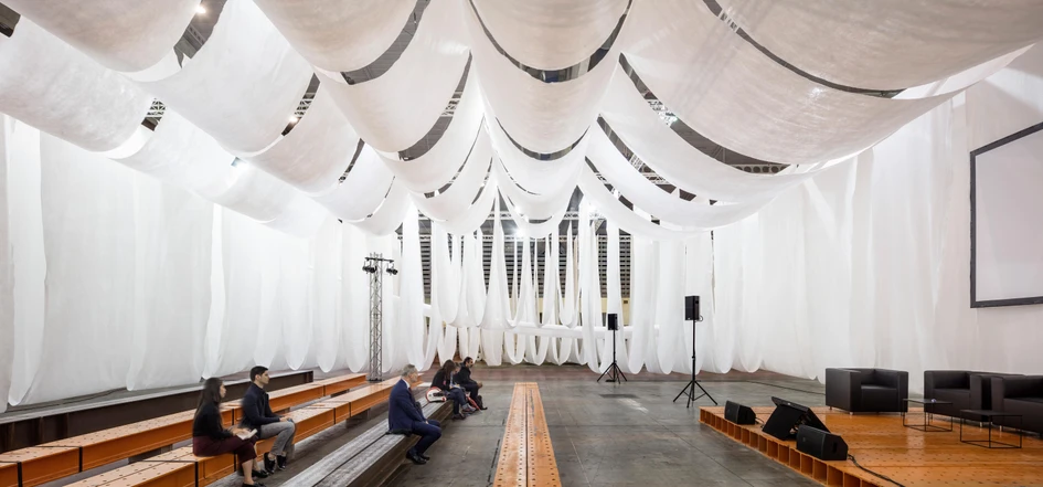 The interplay of heavy steel and light textiles in Josep Ferrando Architecture's Barcelona Building Construmat Ephemeral Space also aims to showcase the interplay of permanent and temporary components used during building construction. Photos: Adrià Goula