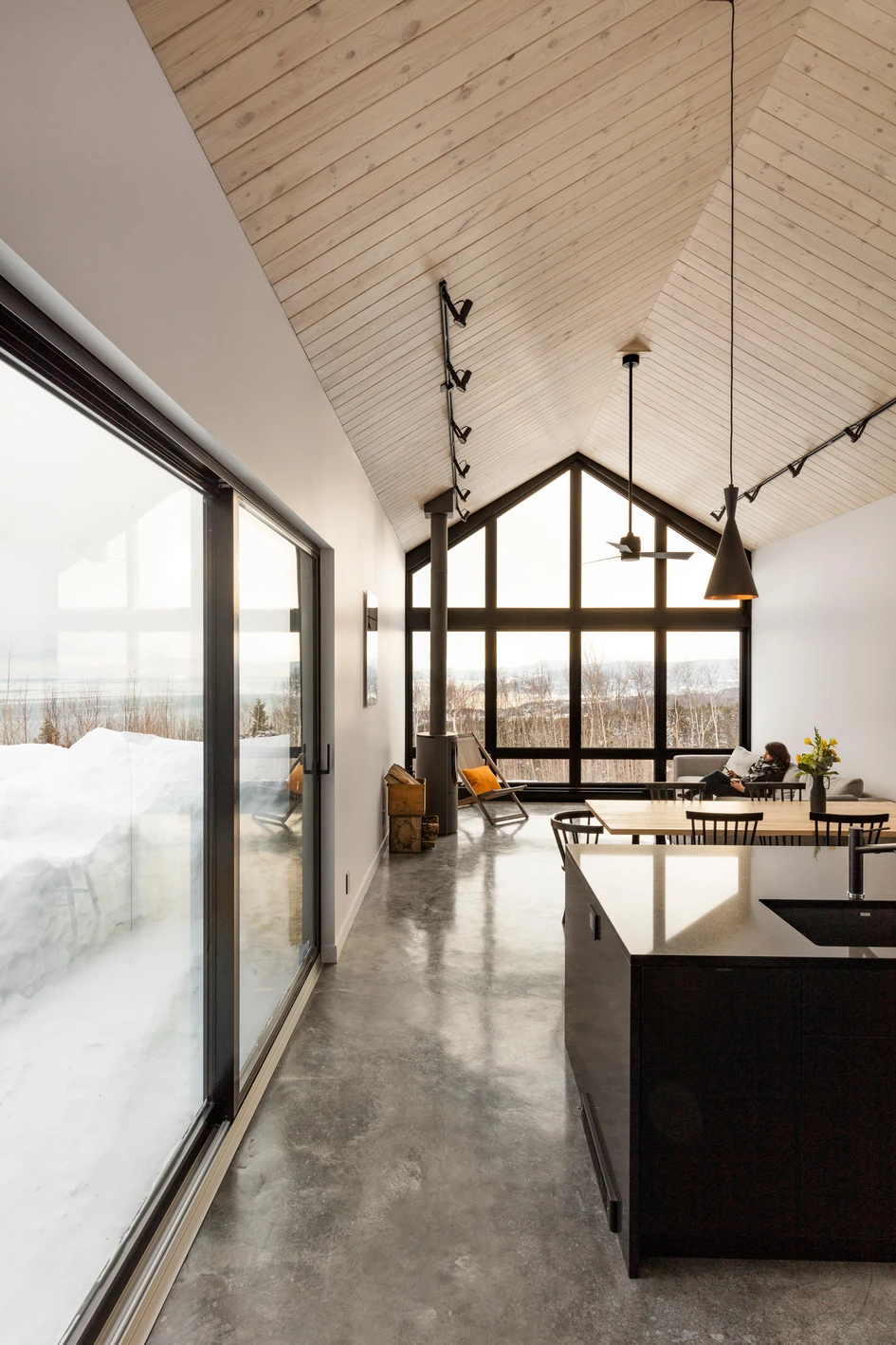 Chalet du Bois Flotté, the mountain home designed by Atelier BOOM-TOWN features a simple, Scandinavian-inspired material palette of concrete floors, white walls and timber ceilings. Photos: Maxime Brouillet