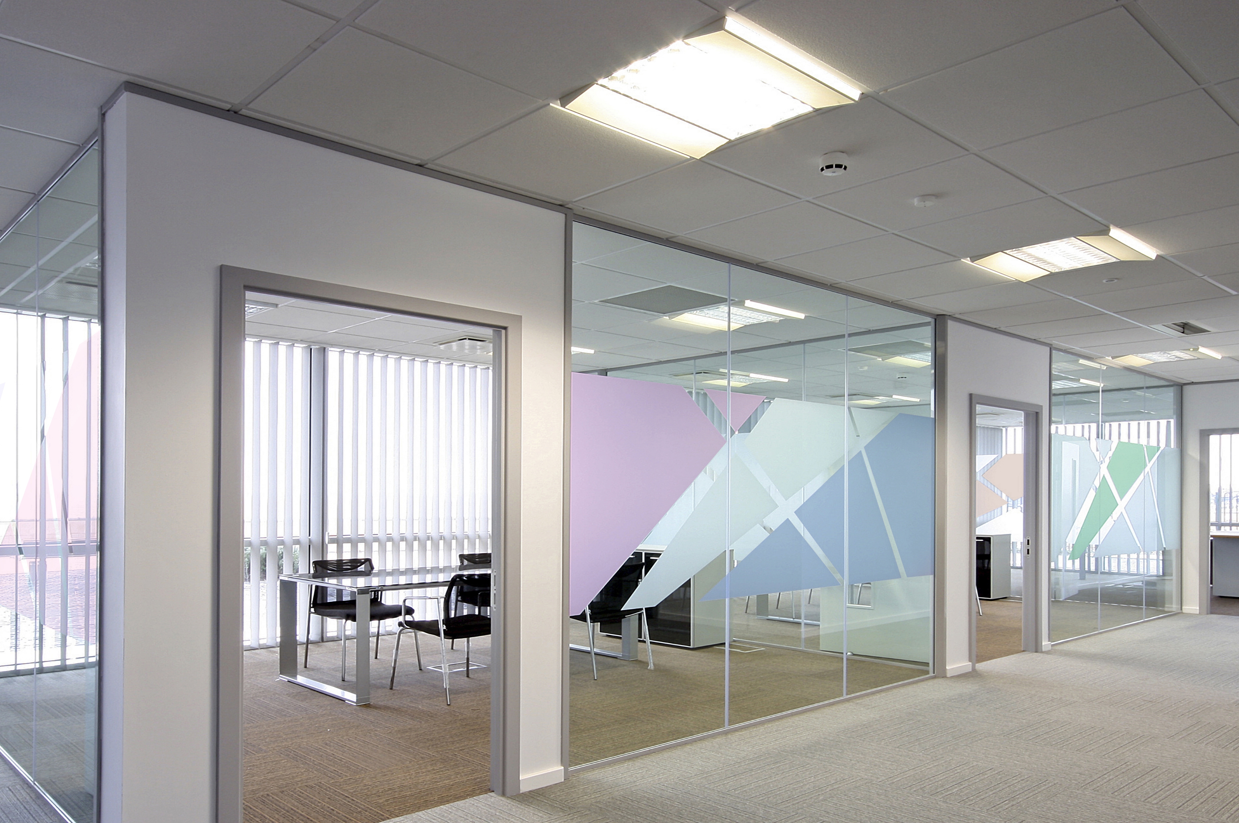 Colourful graphics with an etched glass finish can add much-needed character and originality to otherwise interchangeable areas of the workplace