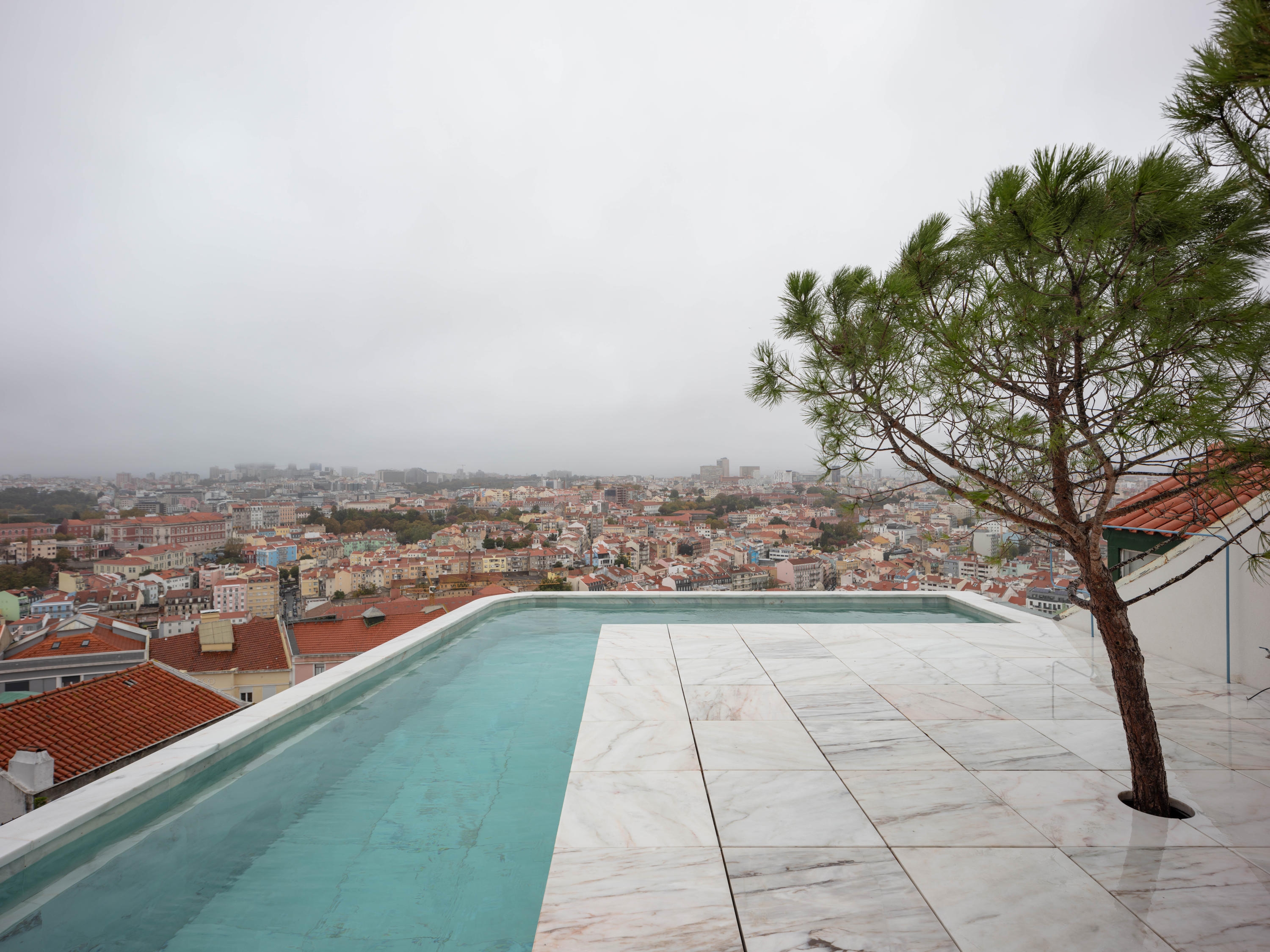 The roof terrace of Leopold Banchini’s Casa Do Monte, surrounded by the blue waters of the pool. Photo: Dylan Perrenoud