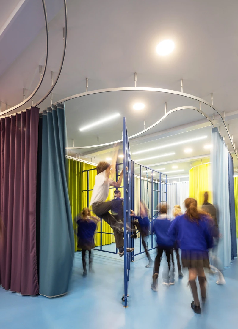 Using brightly coloured textile curtains in their Rosemary Works School, Aberrant Architecture have created a playful, multipurpose space fit for young pupils. Photos: Simon Kennedy