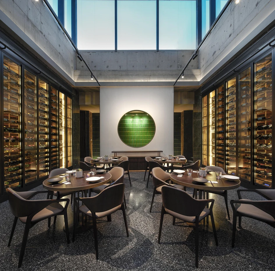 The interior of Funun Lab's JE Beijing Restaurant features earthy tones such as dark green, grey and copper, creating an even more pronounced contrast with the scarlet staircase. Photos: Ruijing Photo