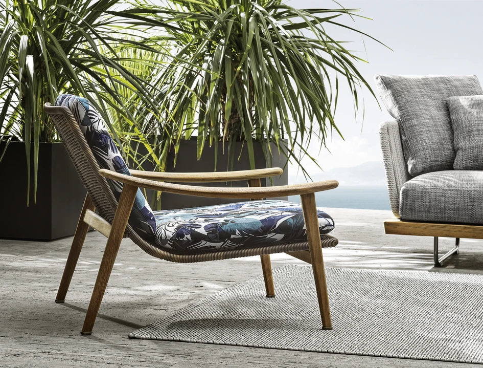 Top: GamFratesi’s Fynn dining table has curved corners that echo the armchairs’ curvilinear armrests. Above: A Fynn armchair upholstered with an on-trend tropical print