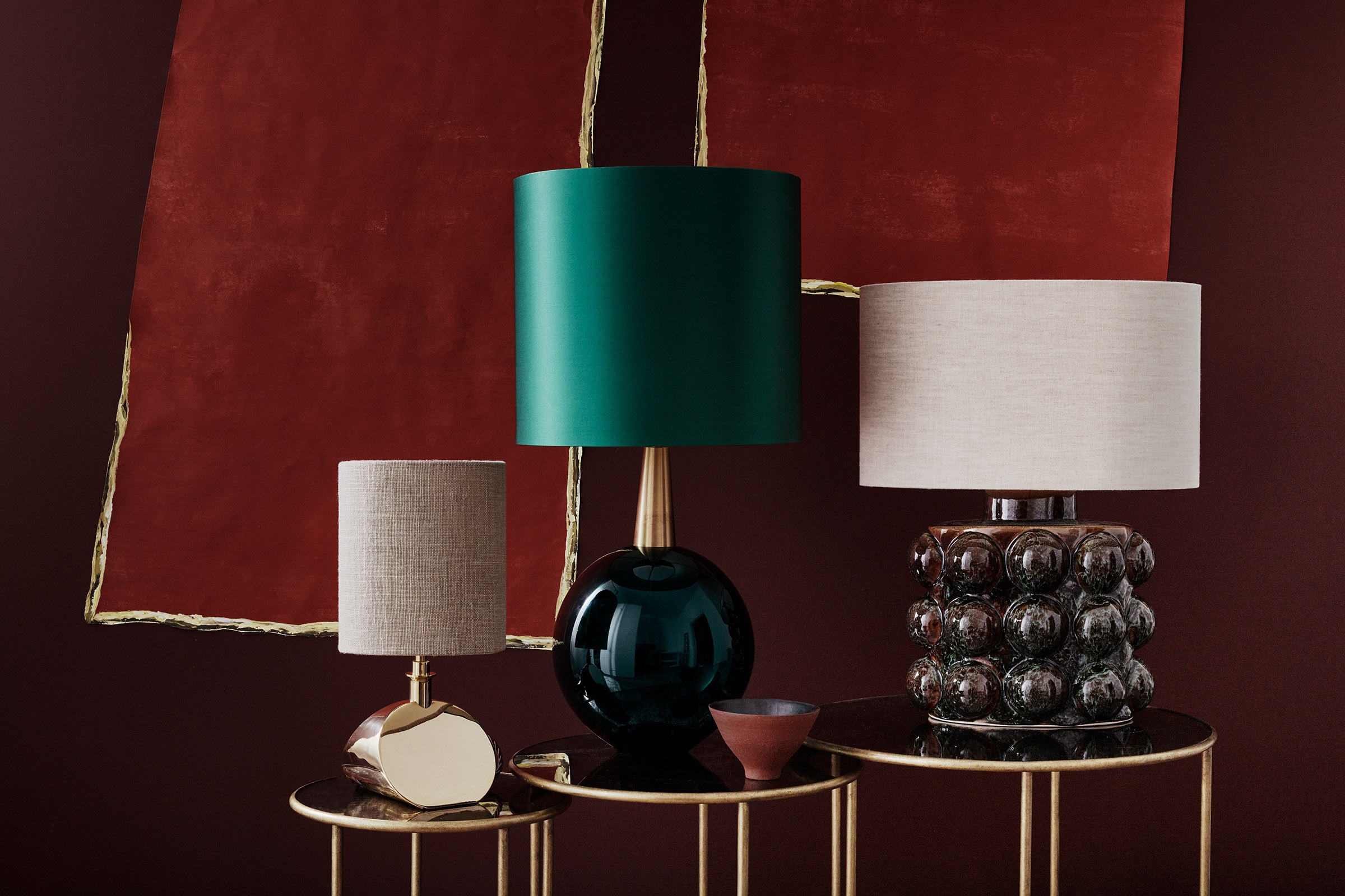 Top: Porta Romana’s Cocoon and Orb pendant lights above the Large Miro Centre table with a French brass base and dark fumed oak top. Above, from left to right: Sway, Bishop and Boublé lamps on the Lilypad nest of tables