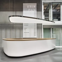 Eight ring lights of different sizes provide a stylish atmosphere in the café (top). The shapely light sail above the reception counter not only serves as lighting but also regulates climate and sound (centre and above)