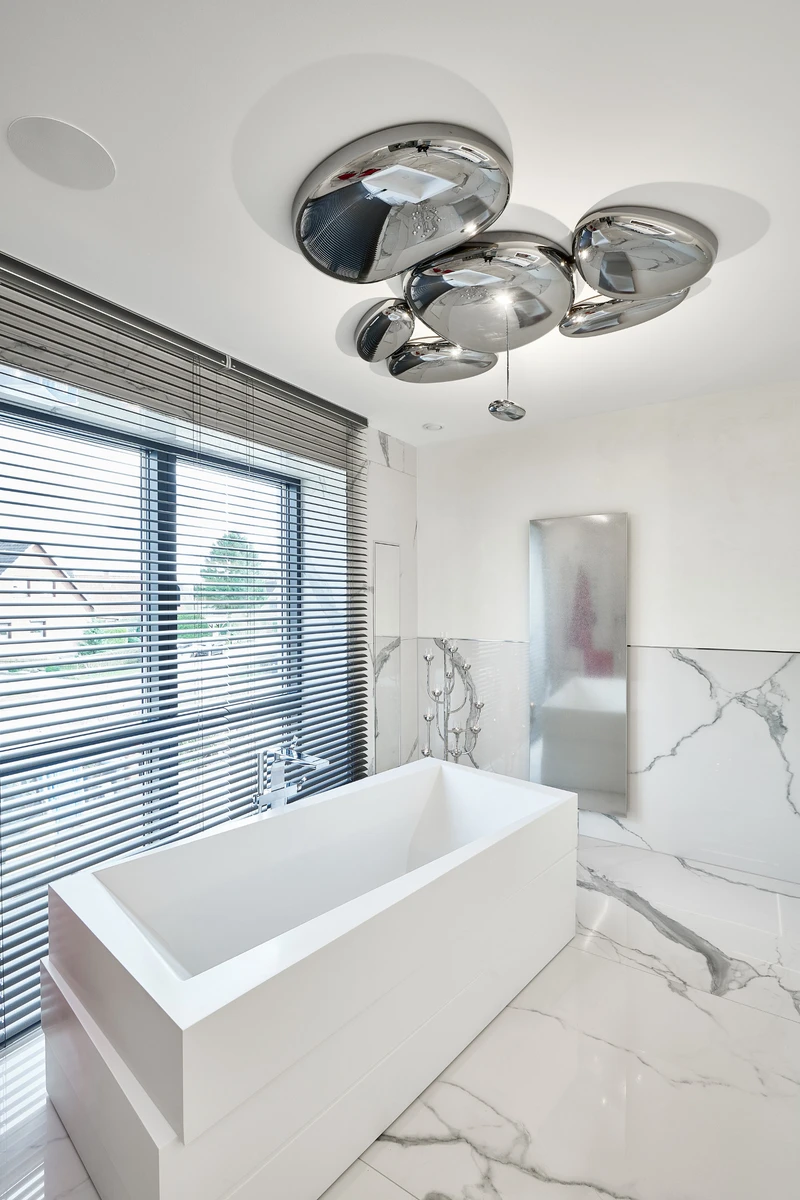 A diffuse-light-emitting version of the A.24 system is utilised in the bathroom and traces the architecture. In the second bathroom, the organically shaped Skydro luminaire reflects the surroundings like wet pebbles