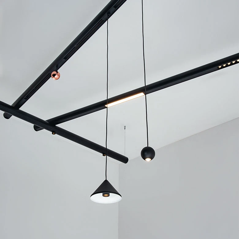 Designers can create sculptural installations using pendants and spotlights that attach anywhere along the lengths of the minimal aluminium tubes