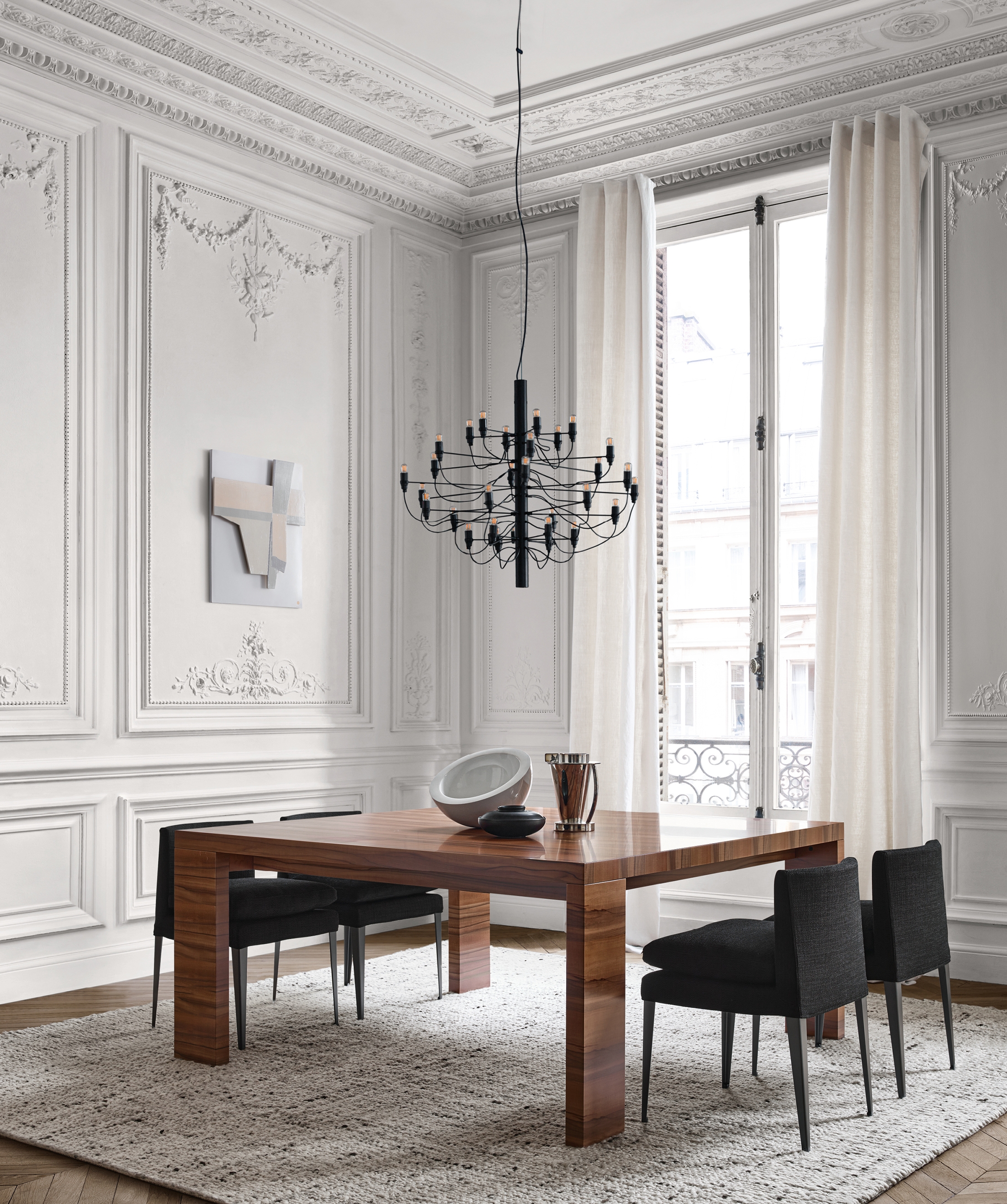 Rich brown lowlights join softly monochrome tones; seen here in the leather Febo chairs (above) and the Abseo table (below) in Chilean tineo wood