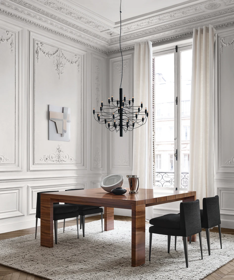Rich brown lowlights join softly monochrome tones; seen here in the leather Febo chairs (above) and the Abseo table (below) in Chilean tineo wood