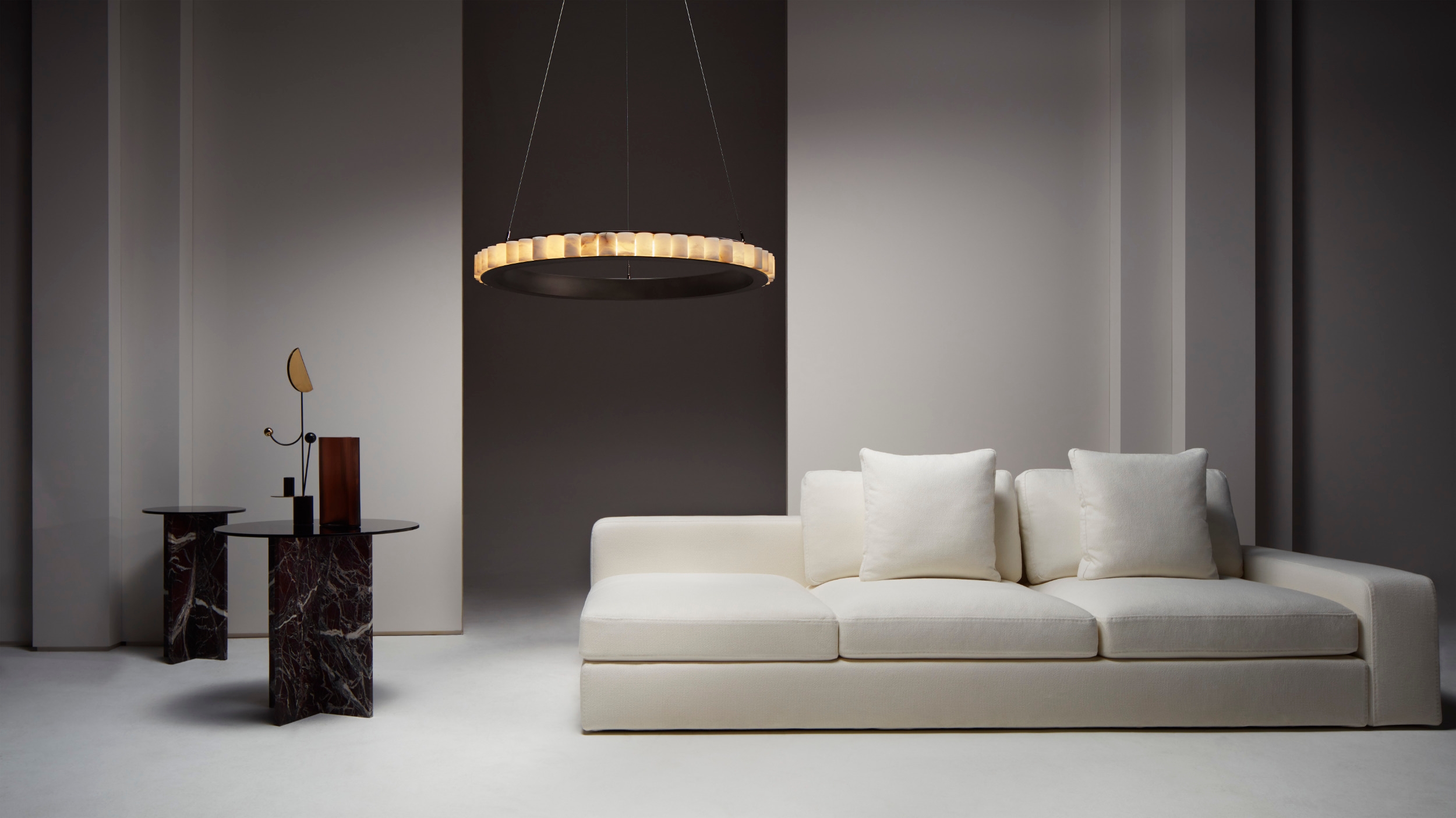The translucent alabaster columns are arranged around a circular frame which comes in a choice of two different finishes: CTO Lighting’s signature smoky bronze or vibrant satin brass