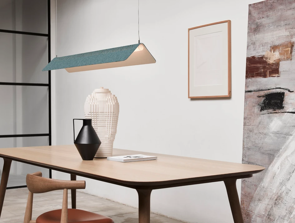 With Flybye’s identically-perforated felt-like Divina MD cover from Kvadrat laid on its back, the suspension or table lamp is given a splash of colour, taking on a fun and playful new personality