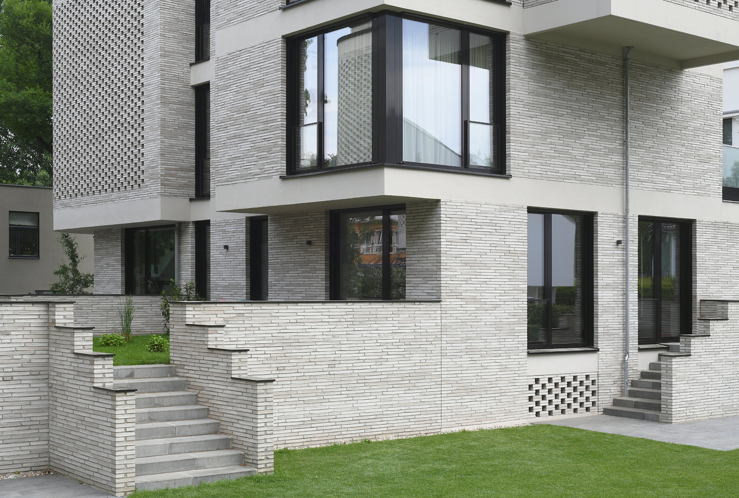 The eye-catching brickwork wrapped around these characterful twinned Berlin buildings creates a striking optical illusion, replicated on its balconies and basement walls