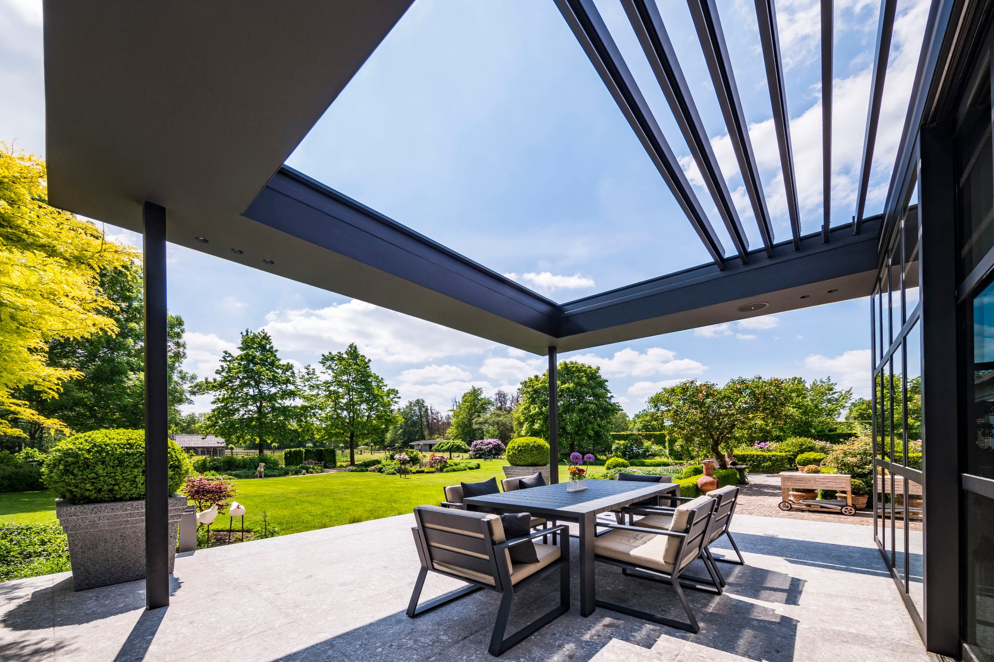 A frame for outdoor living, the Renson Aero Skye patio cover has a louvred roof with flexible blades for sun and rain protection when needed