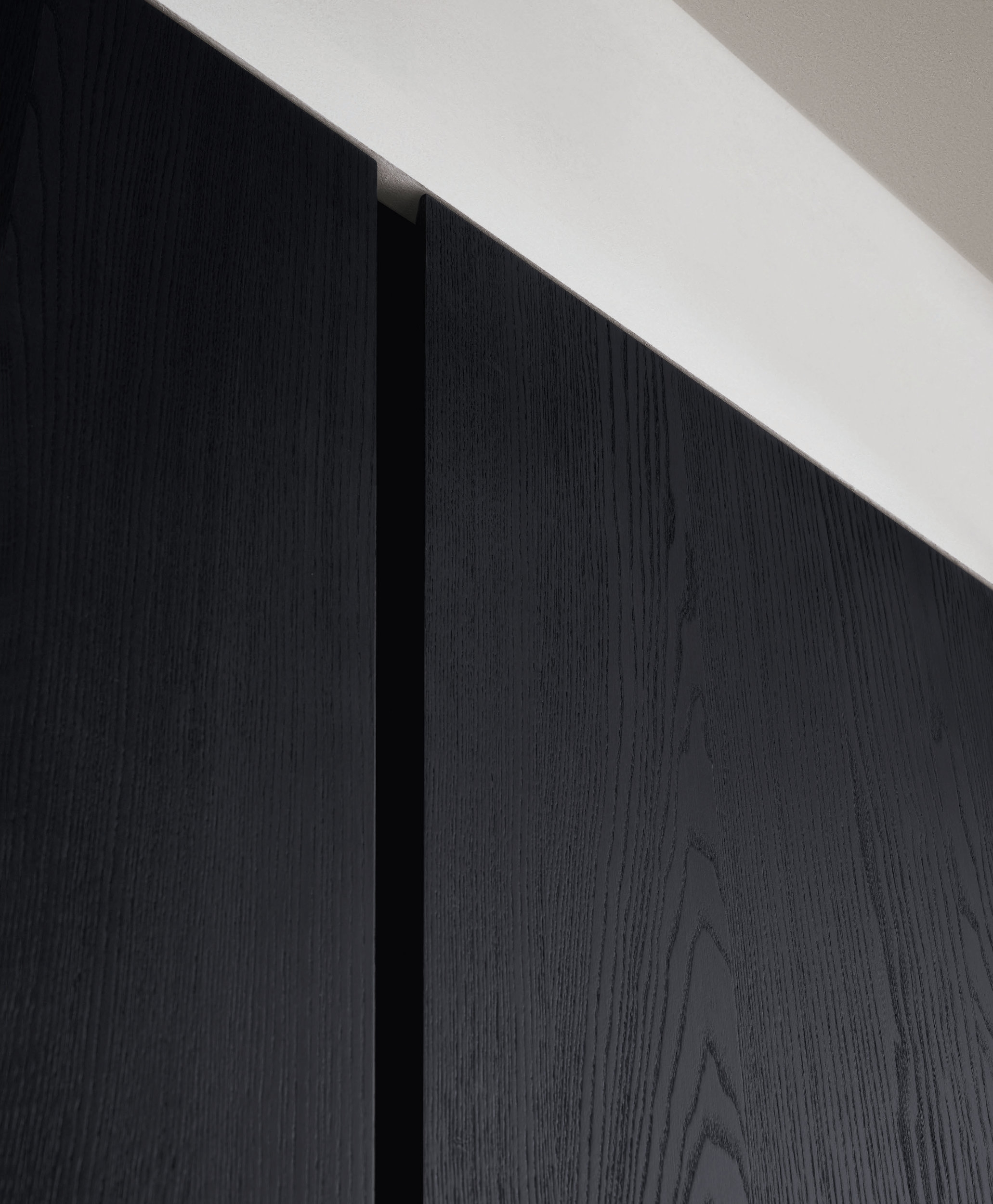 The Gola Profile works horizontally for under-the-counter units, and vertically for the tall cabinets that are used to divide up the wet and show zones of the kitchen