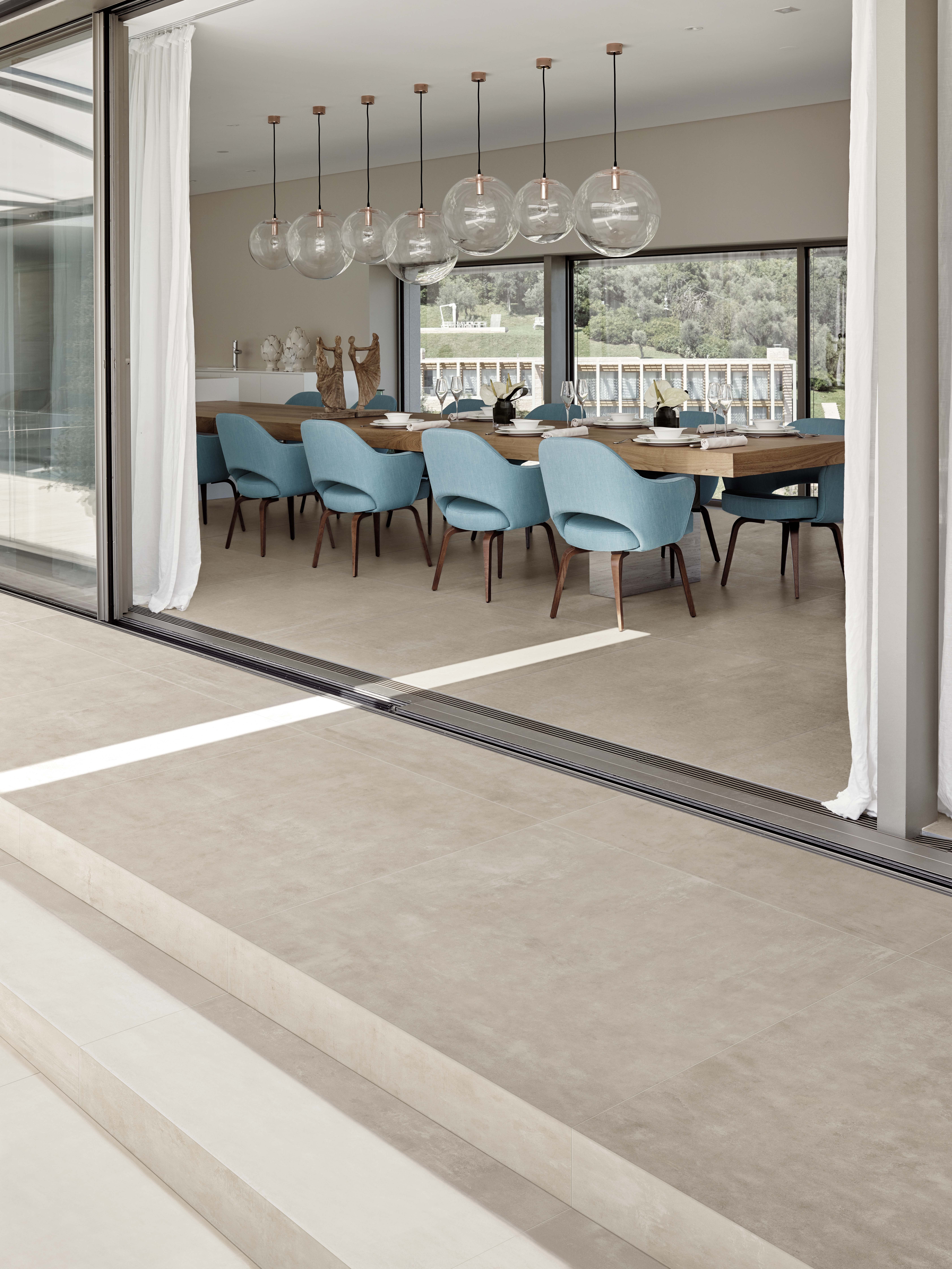 With so many sizes and trim options on both sides of the divide, an entirely flush fit creates a seamless relationship between flooring and architectural necessities, like trip-free sliding doors. Photo courtesy of Atlas Concorde