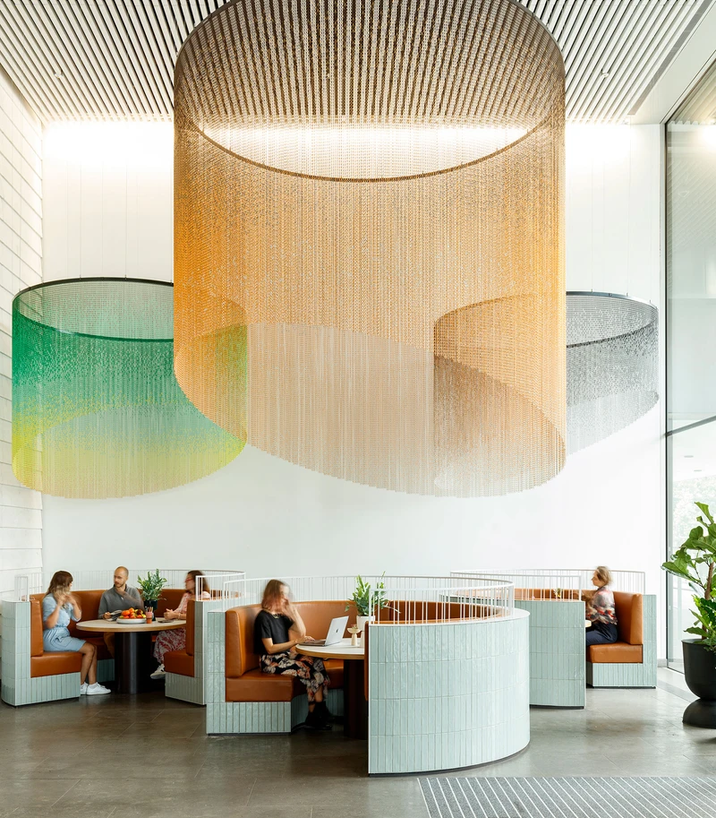 Aldgate Tower, London, UK: In this subtle architectural intervention, circular, ceiling-hung curtains echo curved seating booths, signalling different zones