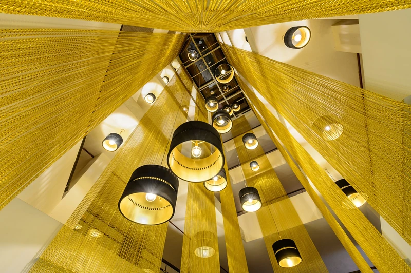 Opulent, ceiling-hung curtains radiating from large entrances create a spectacular look (top: Stora Hotellet, Umeå, Sweden). The dramatic installation at the Aparthotel Playasol Jabeque Soul, Ibiza, Spain, evokes beams of golden light 