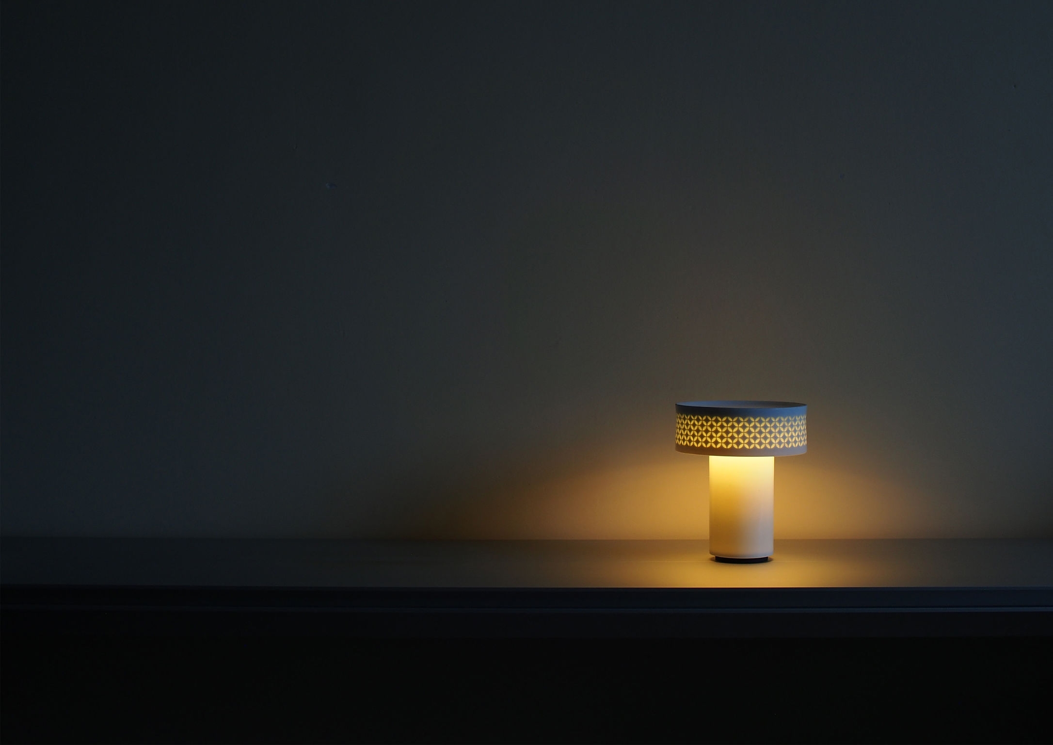 Traditional Japanese washi paper serves as the diffuser of the And-on table lamp by Saltco for Y.S.M. (top), while Royoko has created the Fú lamp (above) using Chinese rice grain porcelain