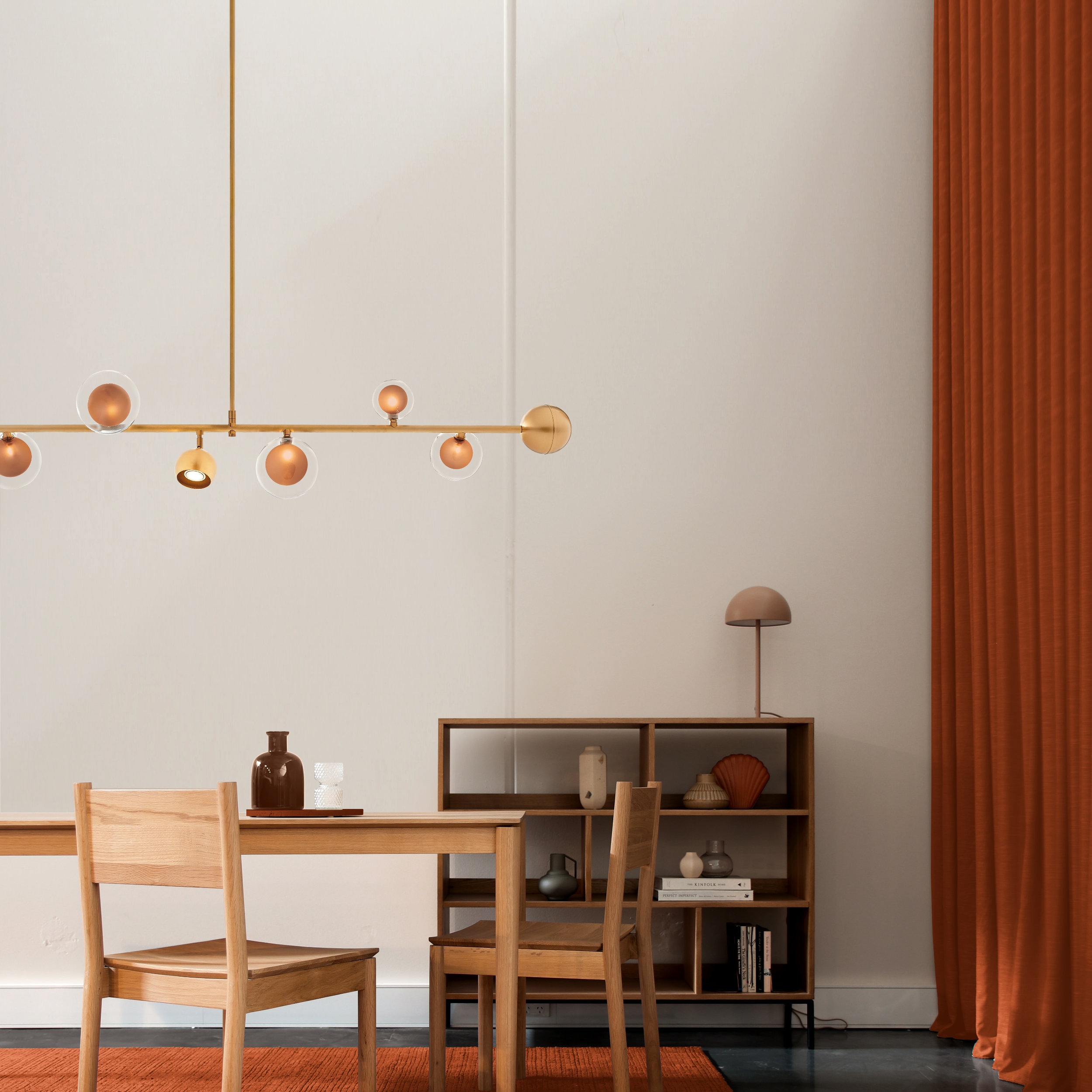Part of Shakúff’s new Bloom collection, the Bloom chandelier features bud-like glass pendants and a central adjustable reading light blossoming from an elegant brass rod 