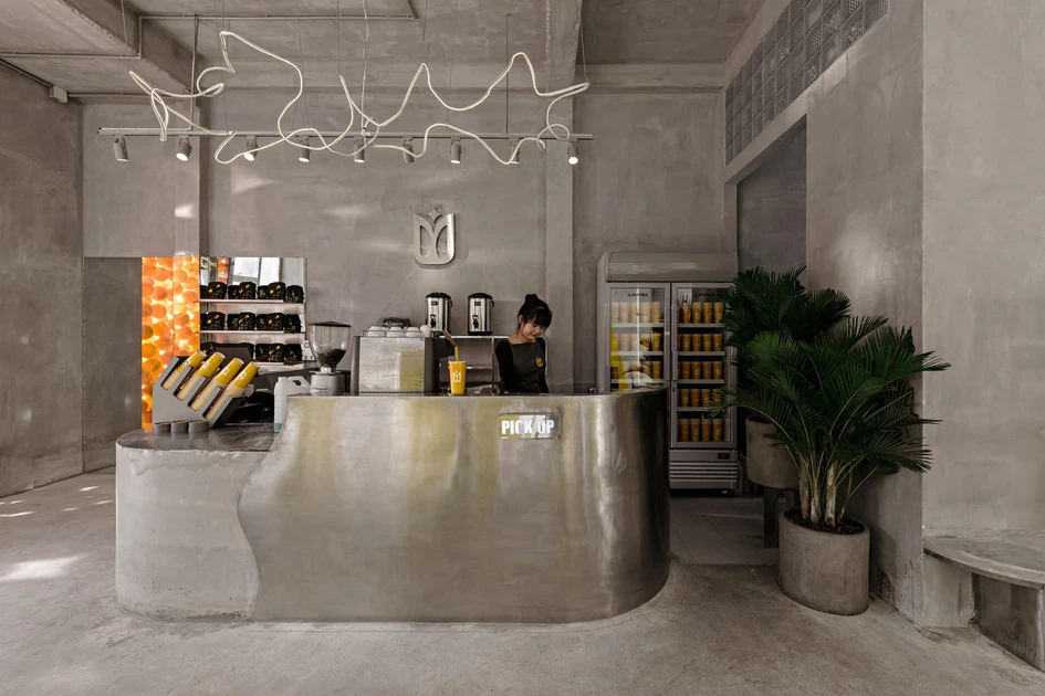 YAMA Coffee Shop's concrete interiors, designed by KSOUL Studio feature exposed concrete walls and delicate furniture meaning the background becomes the space's defining feature. Photos: Valor Studio