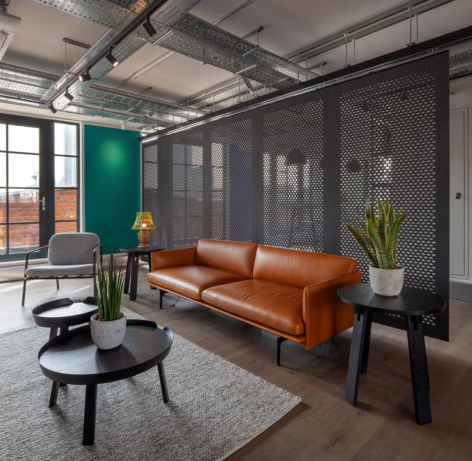 Suspended acoustic screens divide a space in the London showroom of Autex Acoustics. The sound-absorbing Cascade panels shown are made from 100 per cent recyclable polyester