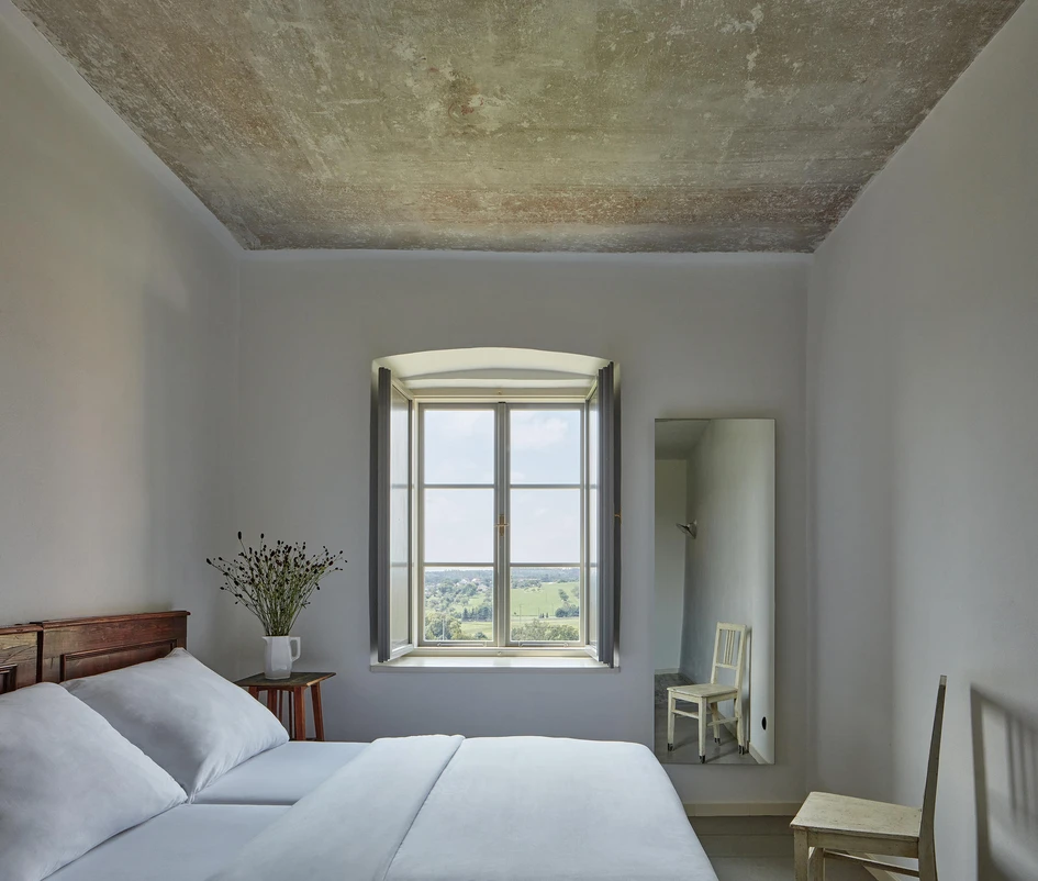 Exposed and whitewashed walls, as well as antique furniture, add to the rustic appeal of the renovated Kocanda hotel in Kravsko, Czech Republic, by local practice ORA. Photos: BoysPlayNice