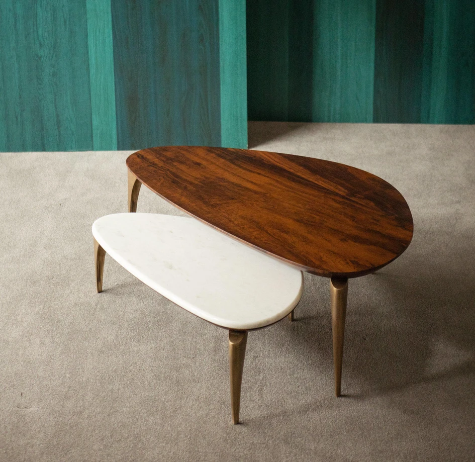 The Tenoch cabinet's brass facade evokes the Aztec Empire (top). The Manolo Model S table, available in a choice of woods or marbles and supported by hand-cast metal legs, shuns straight lines but nevertheless feel thoroughly modern