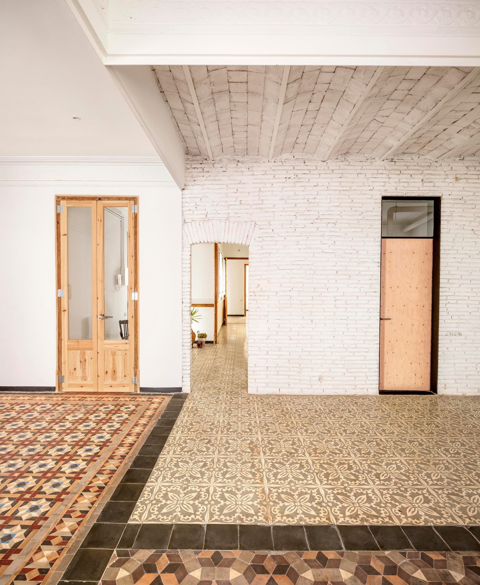 Agora Arquitectura's 27+14 Apartment refurbishment in Barcelona celebrates the vibrant colour and pattern combinations of the space's original floors. Photos: Adrià Goulà