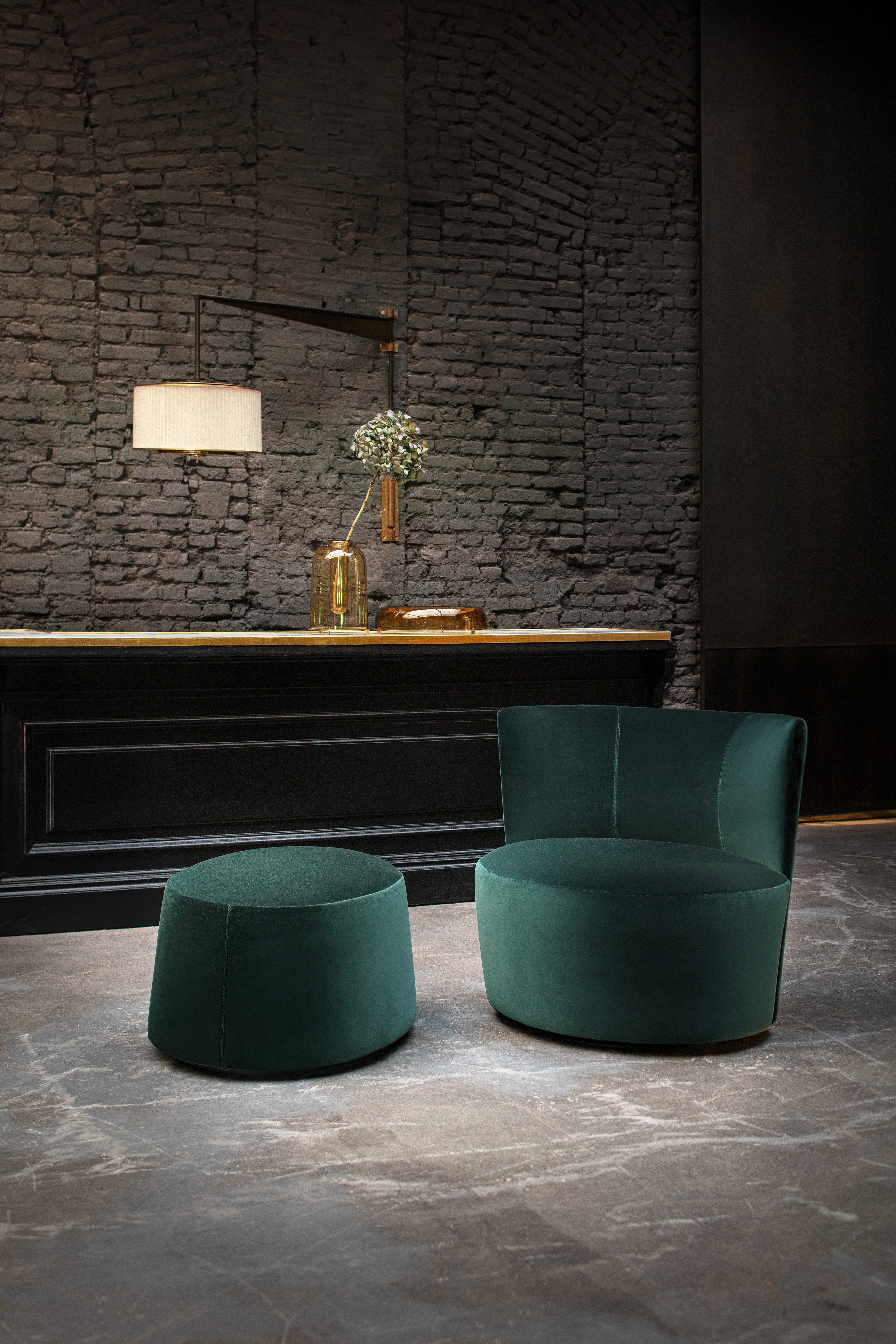 Alongside its complementary pouf, the Emily armchair has a timeless elegance, while at the same time inviting you to stretch out and put your feet up