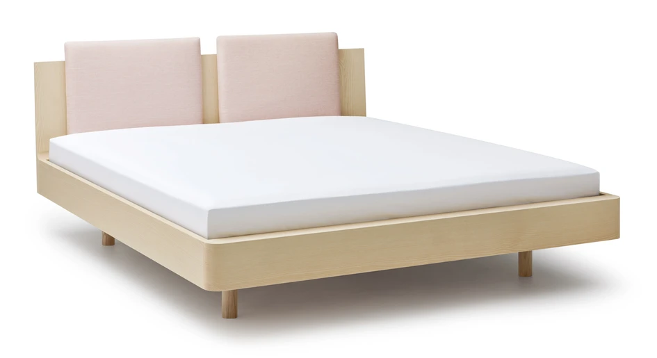 The headboard is available in two heights, while pillow covers made from Kvadrat textiles ensure comfort when reading, or even watching TV in bed