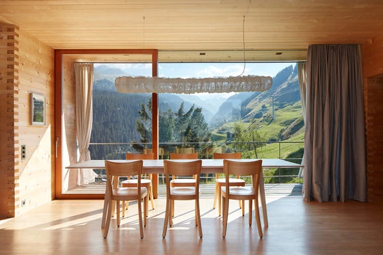 Peter Zumthor's holiday homes in Leis, Switzerland, overlook the landscape. Photo: Ralph Feiner