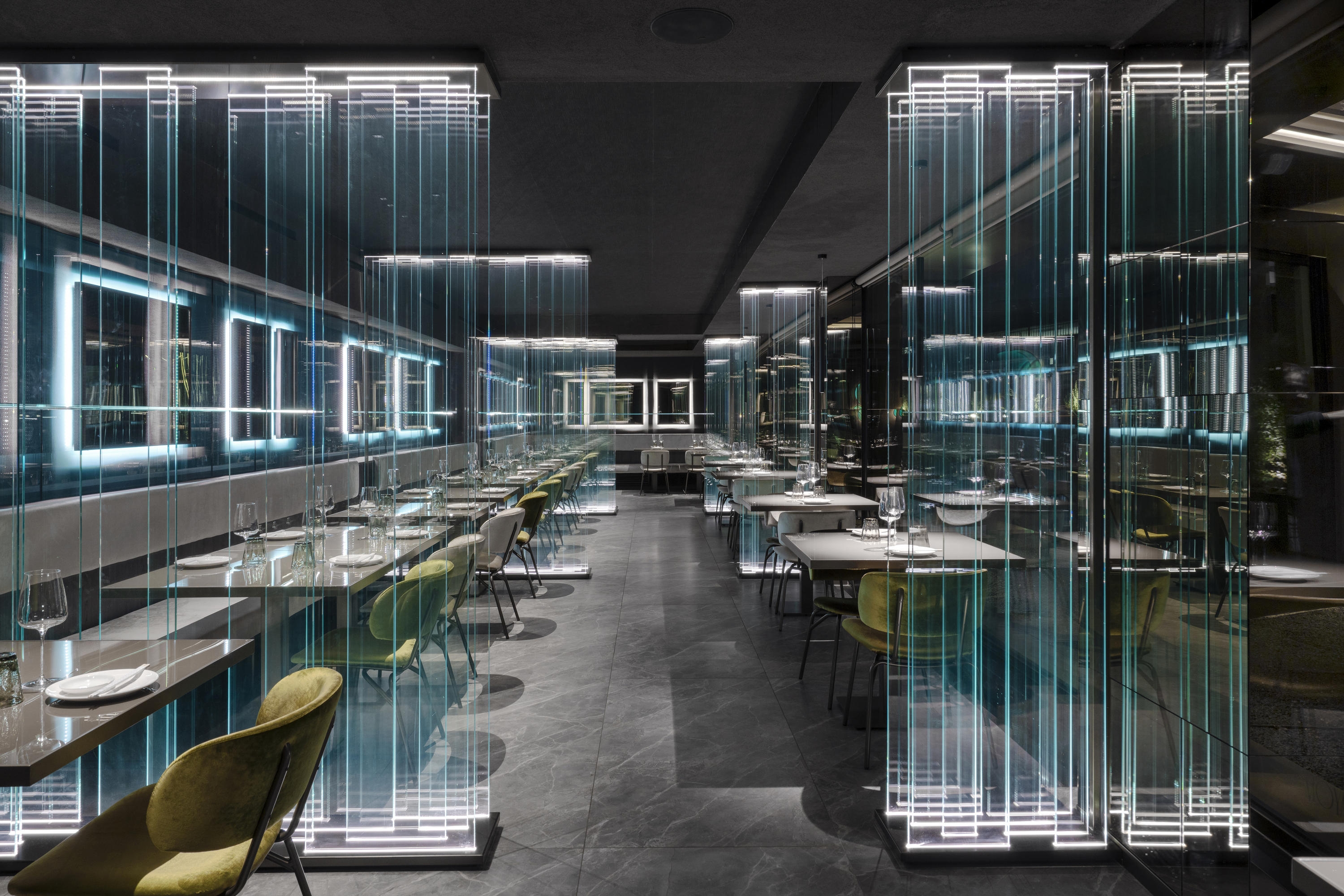 Transparent glass features as a striking installation, as well as subtle partitioning, in the Moya restaurant in Como, Italy. Photo: Andrea Martiradonna