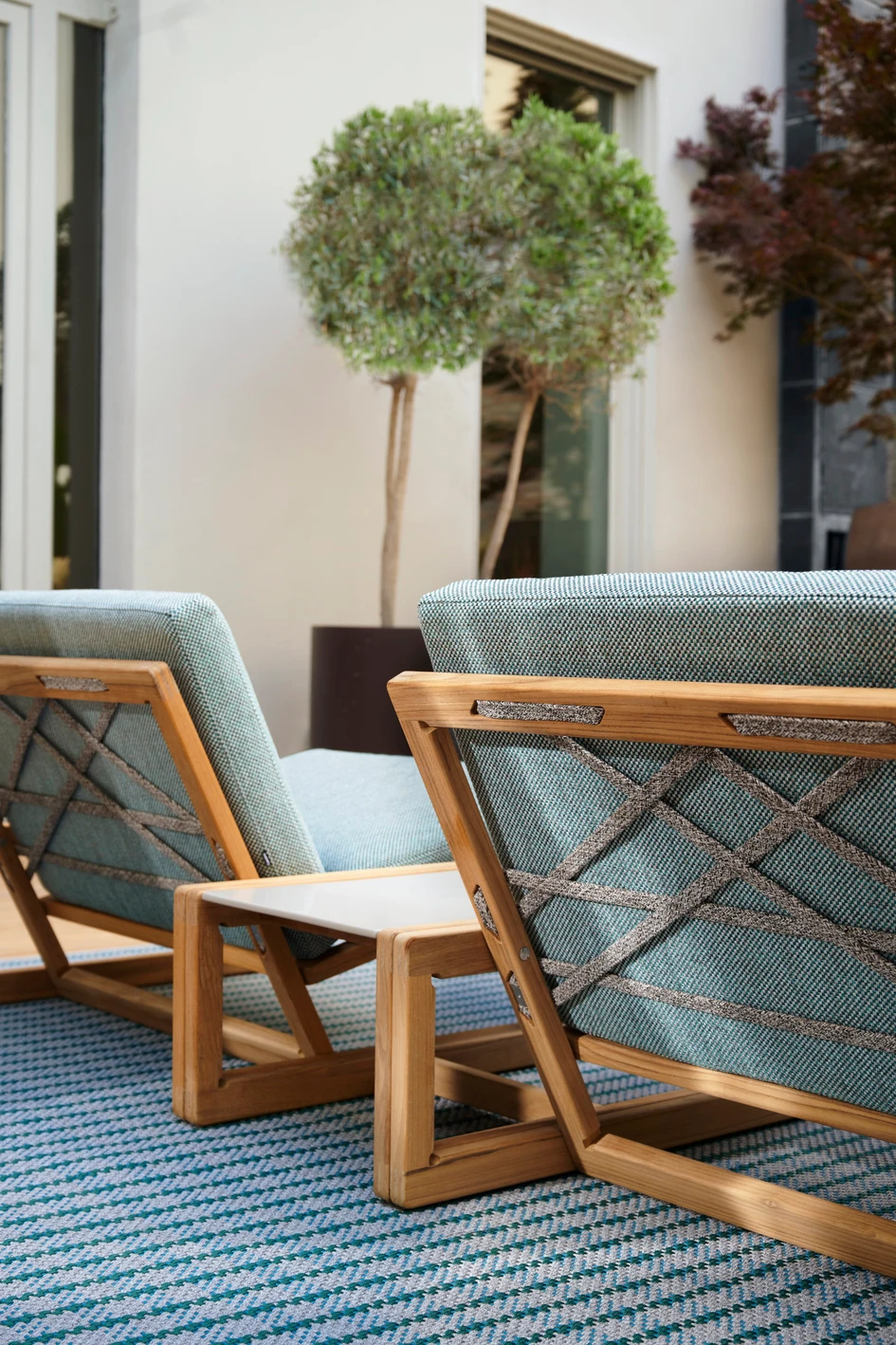 The carpentry details of the Carlotta small armchair have been faithfully reproduced in teak and a complementary coffee table has been created in three sizes. Photo: Valentina Sommariva