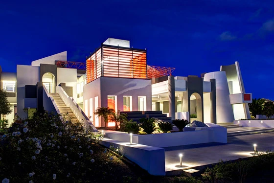 The Shenzhen Gemdale Center (top) outlines its facade with light, while the Dar Il-Hanin Samaritan house's assorted sculptural garden structures (bottom) are lit up like art exhibits. Photos: Shu He & L&L Luce&Light