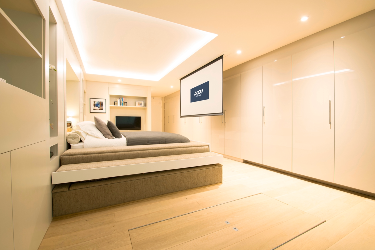 In YO! Home's prototype 40-sqm studio apartment, the table, seating and cushions pack away into underfloor storage while the bed can be lowered to rest over a sunken sofa. Photo: YO! Home