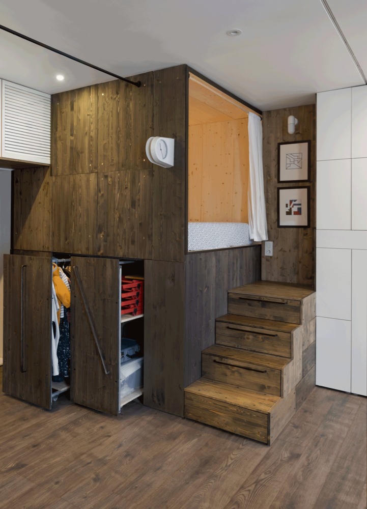 Studio Bazi's floor plan moves the bed above pull-out clothes storage, utilising the entrance space as a dressing area. Photo: Ilya Ivanov