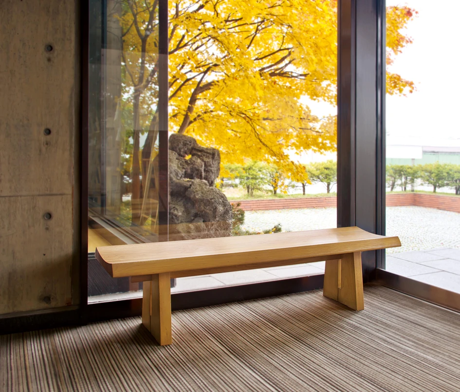 The Riki Bench by Conde House has a slightly concave seat that helps users comfortably slide across it