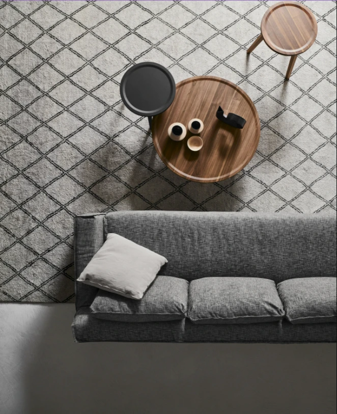 Gervasoni's Gray is a series of raised rim furniture pieces including side, coffee and console tables, as well as chairs