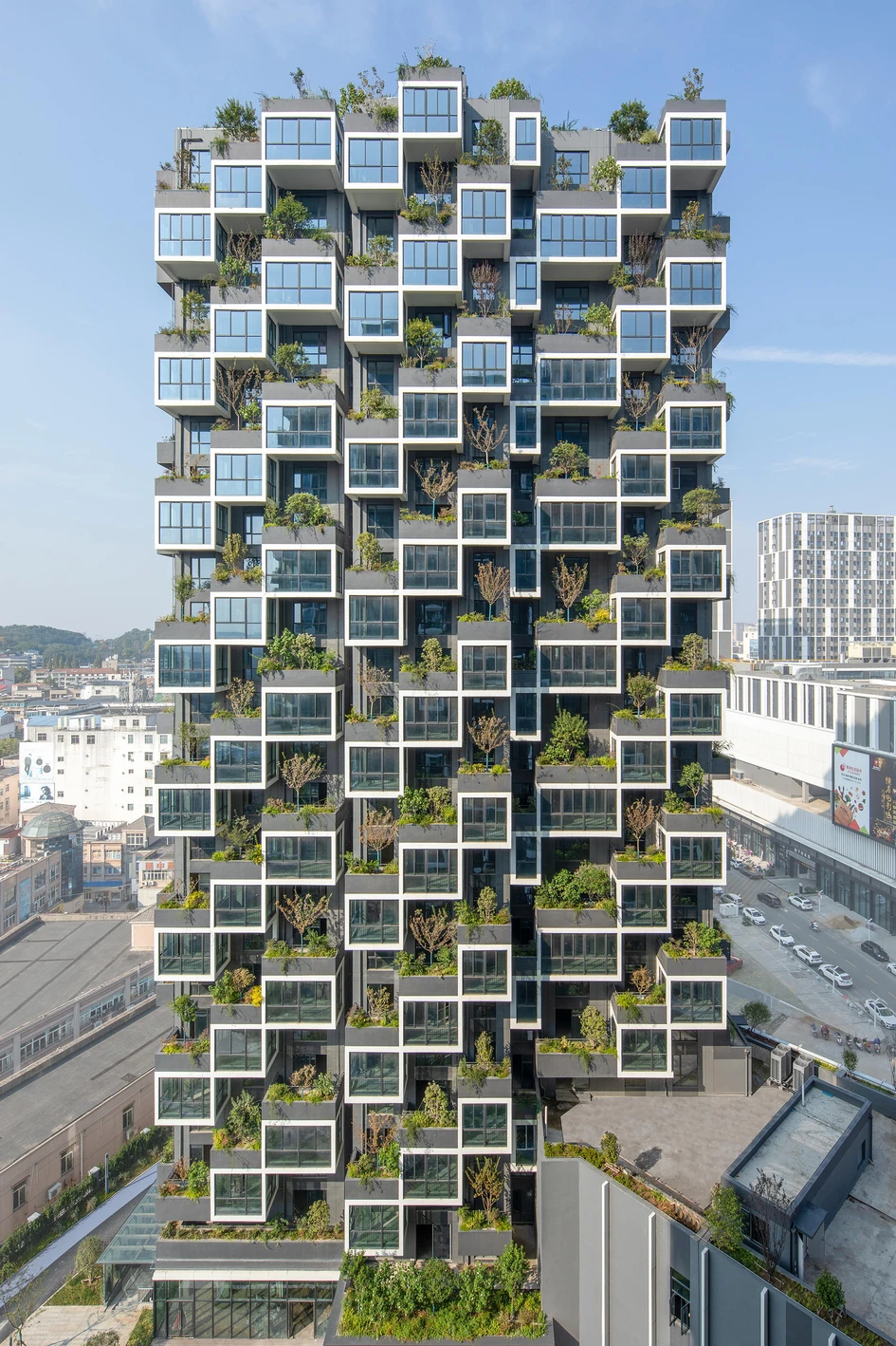 Stefano Boeri Architects' Easyhome Huanggang Vertical Forest City Complex creates mini-parks with trees and shrubbery planted on each enclosed balcony's canopy. Photo: RAW VISION studio