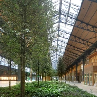 The Gare Maritime Workspace is a covered city with workplaces, retail units and wide boulevards, surrounding a central event space and gardens. Photos: Filip Dujardin © Neutelings Riedijk Architects