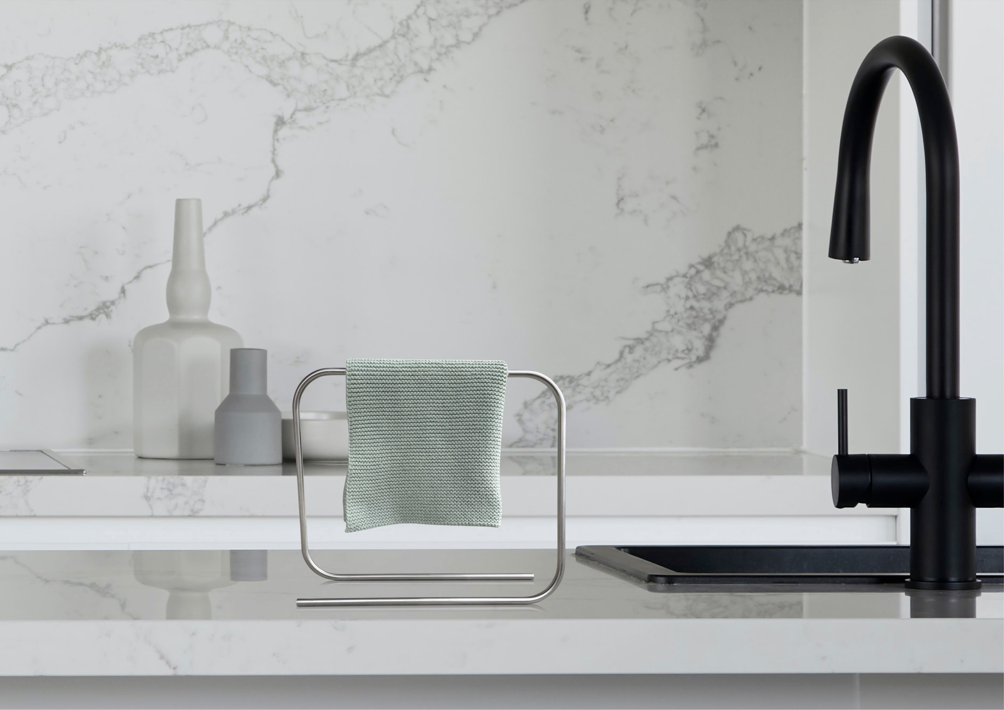 'It's flat, flatter': this is Bette's motto for BetteAir, the first ever shower tile made of glazed titanium steel (top); inbyko's minimalist looper sink cloth holder is available in stainless steel, chrome or gold (bottom)