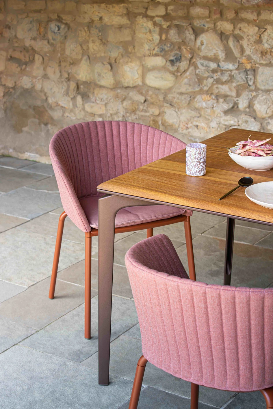 Fast has built on the idea of the outdoor dining room, introducing inviting, tactile materials to its palette. Shown here: Ria armchair with quilted backrest and Allsize table with Iroko table top